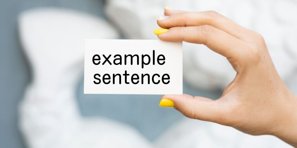 example sentenceと書かれたカードを持つ手の画像