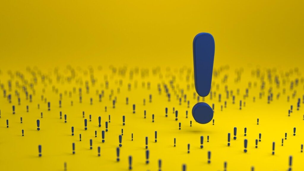 小さくて青い注意マークがたくさん書かれていて、真ん中に大きいマークが有る画像
